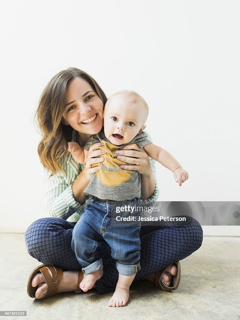 Studio portrait of mother holding baby boy (6-11 months)