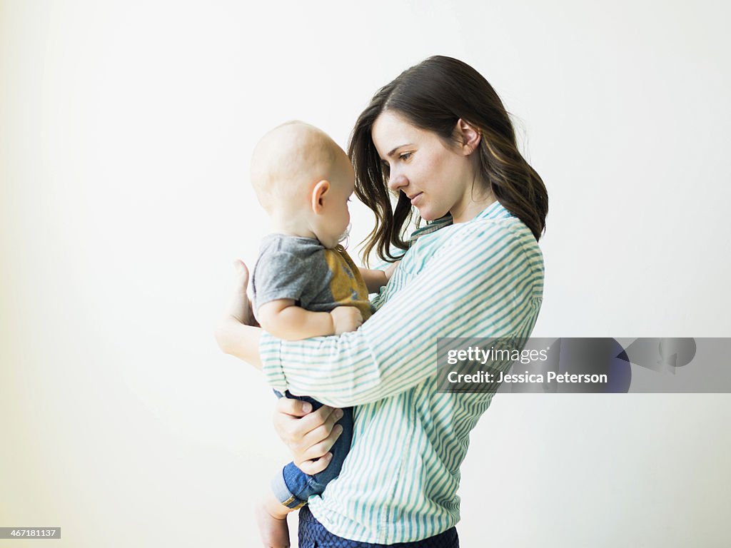 Mother holding baby boy (6-11 months)