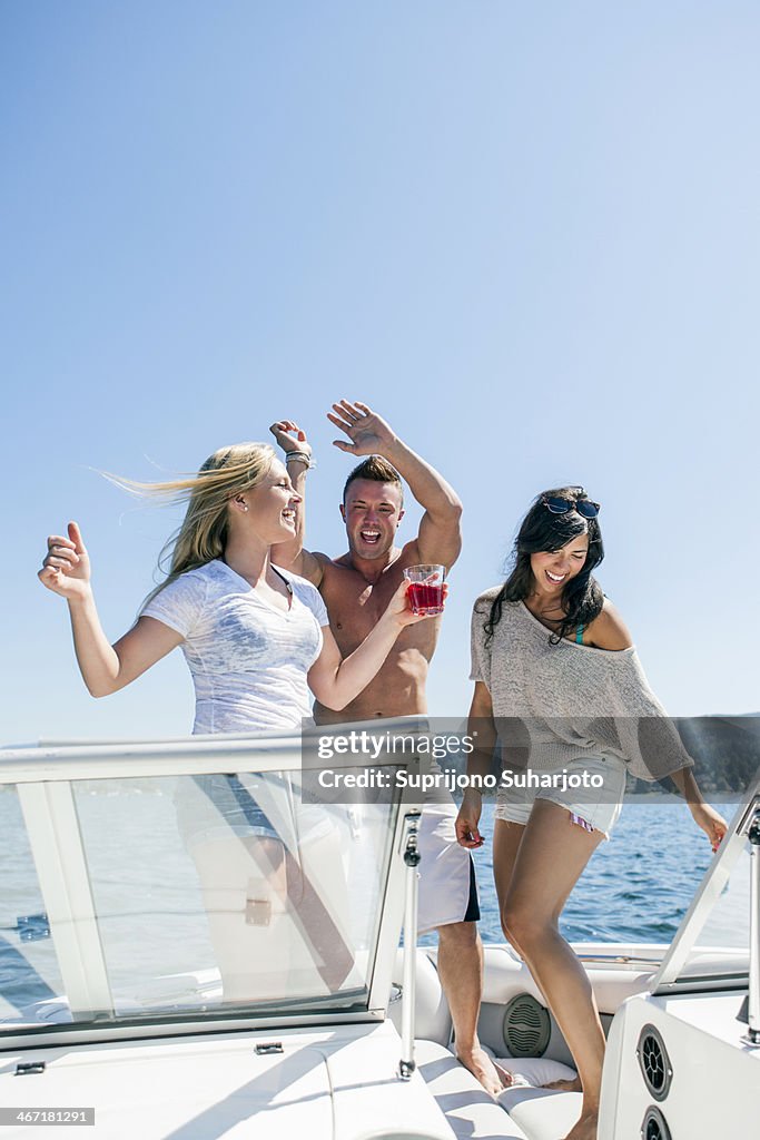 USA, Washington, Bellingham, Young people having fun on motorboat