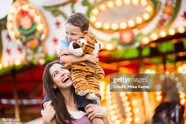 usa, utah, salt lake city, mother giving her son (4-5 ) piggyback ride in amusement park - tiger stock pictures, royalty-free photos & images