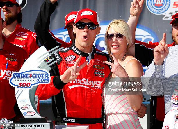 Kevin Harvick, driver of the taxslayer.com Chevrolet, celebrates in Victory Lane with his wife DeLana after winning the NASCAR XFINITY Series...