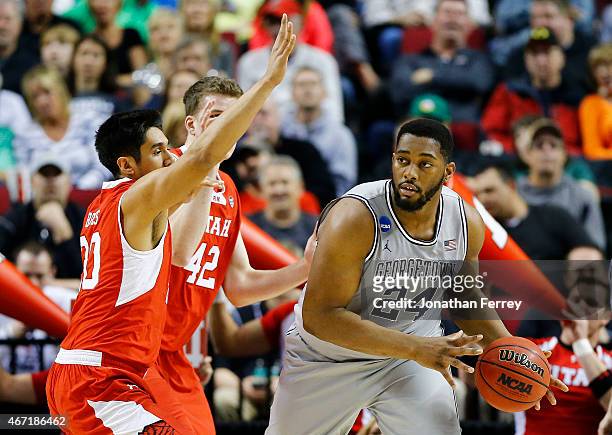 Joshua Smith of the Georgetown Hoyas drives against Chris Reyes and Jakob Poeltl of the Utah Utes in the first half during the third round of the...