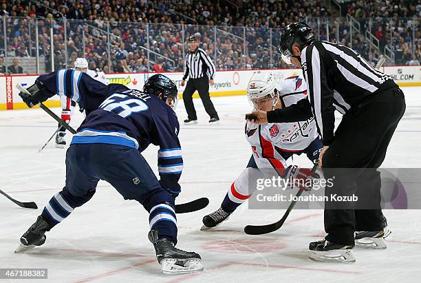 Michael Latta of the Washington Capitals gets set to take a first period face-off against Eric O'Dell of the Winnipeg Jets on March 21, 2015 at the...