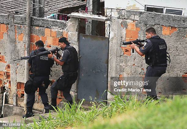 Military Police conduct an operation in the 'pacified' Complexo do Alemao 'favela' community following a shootout earlier in the day on March 21,...