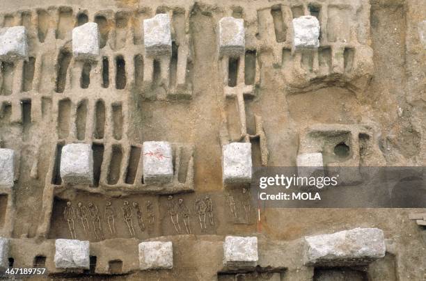 Burial trench and rows of individual graves, excavated between the concrete foundations of the Royal Mint, from the excavation of the Black Death...
