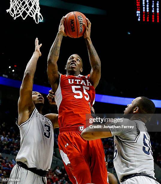 Delon Wright of the Utah Utes goes up against Mikael Hopkins and Jabril Trawick of the Georgetown Hoyas in the first half during the third round of...