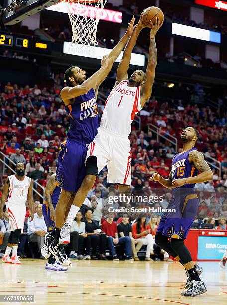 Trevor Ariza of the Houston Rockets goes up for a shot against Brandan Wright of the Phoenix Suns during their game at the Toyota Center on March 21,...