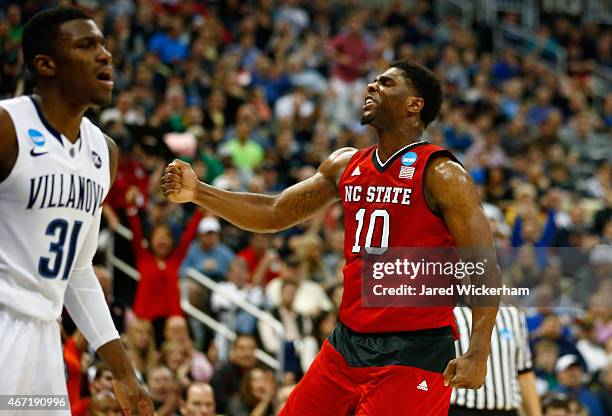 Lennard Freeman of the North Carolina State Wolfpack celebrates after making a shot in front of Dylan Ennis of the Villanova Wildcats in the second...