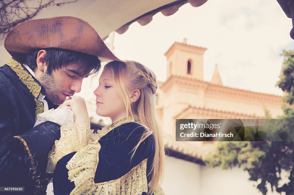 Romeo kissing the juliets hand at balcony