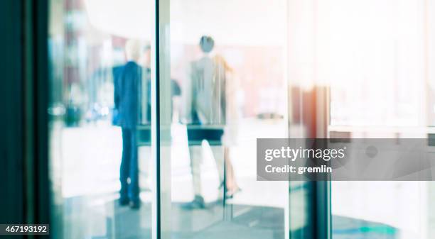 group of business people talking, office building, entrance - revolving door stock pictures, royalty-free photos & images