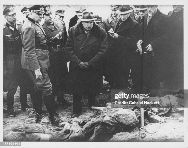 Members of the foreign press and the Katyn Commission watching officials exhume the bodies of the Polish soldiers killed at the Massacre of Katyn...