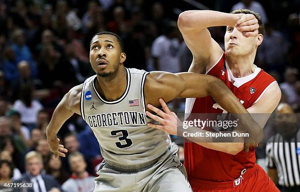 Mikael Hopkins of the Georgetown Hoyas and Dallin Bachynski of the Utah Utes vie for position in the second half during the third round of the 2015...