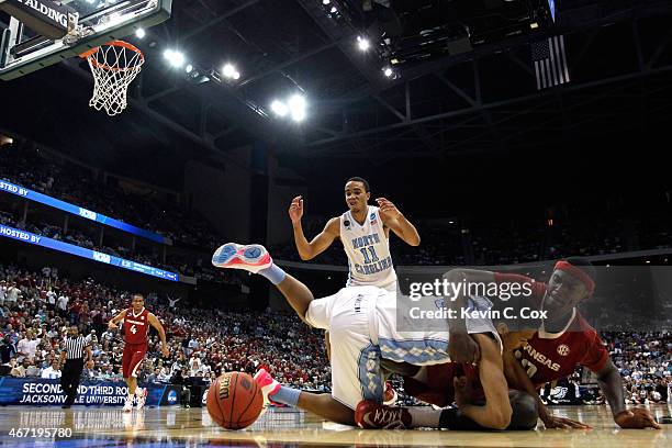 Bobby Portis of the Arkansas Razorbacks and Nate Britt of the North Carolina Tar Heels battle for the ball in the first half during the third round...