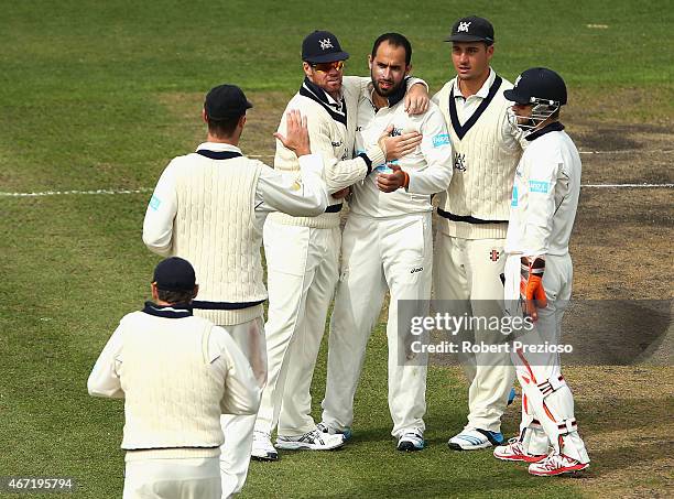 Fawad Ahmed of Victoria celebrates with team-mates after taking the wicket of Sam Whiteman of Western Australia during day two of the Sheffield...