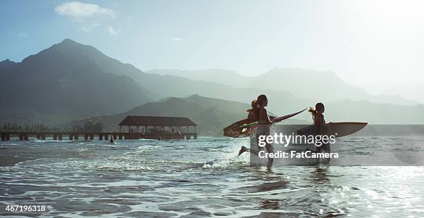 running into the ocean - hawaii beach stock pictures, royalty-free photos & images