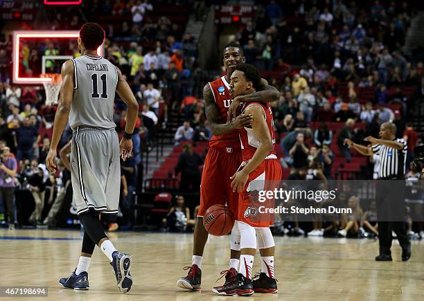 Brandon Taylor and Delon Wright of the Utah Utes celebrate their 75 to 64 win over the Georgetown Hoyas during the third round of the 2015 NCAA Men's...