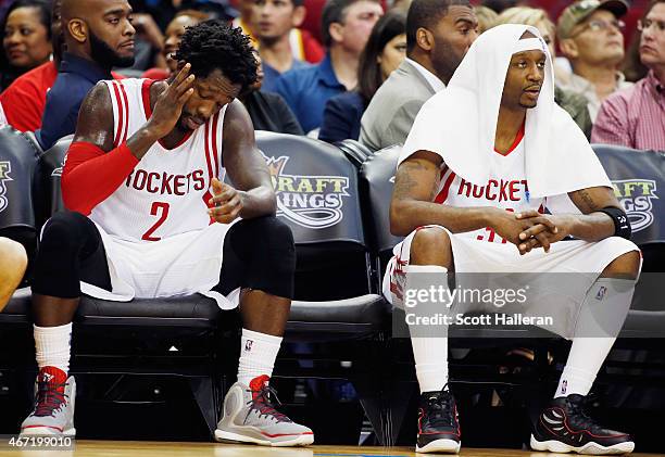 Patrick Beverley and Jason Terry of the Houston Rockets wait on the bench late in their game against the Phoenix Suns at the Toyota Center on March...