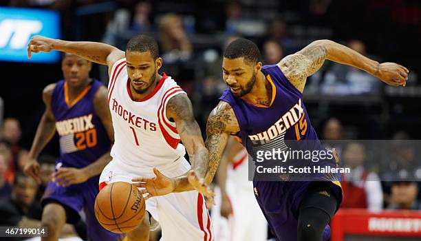 Trevor Ariza of the Houston Rockets and Marcus Morris of the Phoenix Suns battle for a loose basketball during their game at the Toyota Center on...