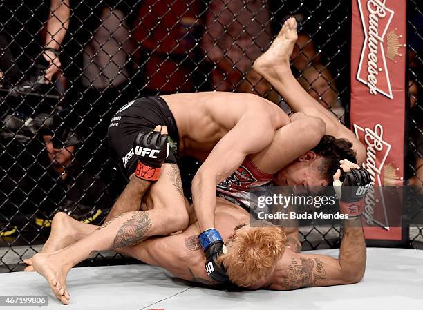 Godofredo Pepey of Brazil submits Andre Fili of the United States in their featherweight bout during the UFC Fight Night at Maracanazinho Gymnasium...