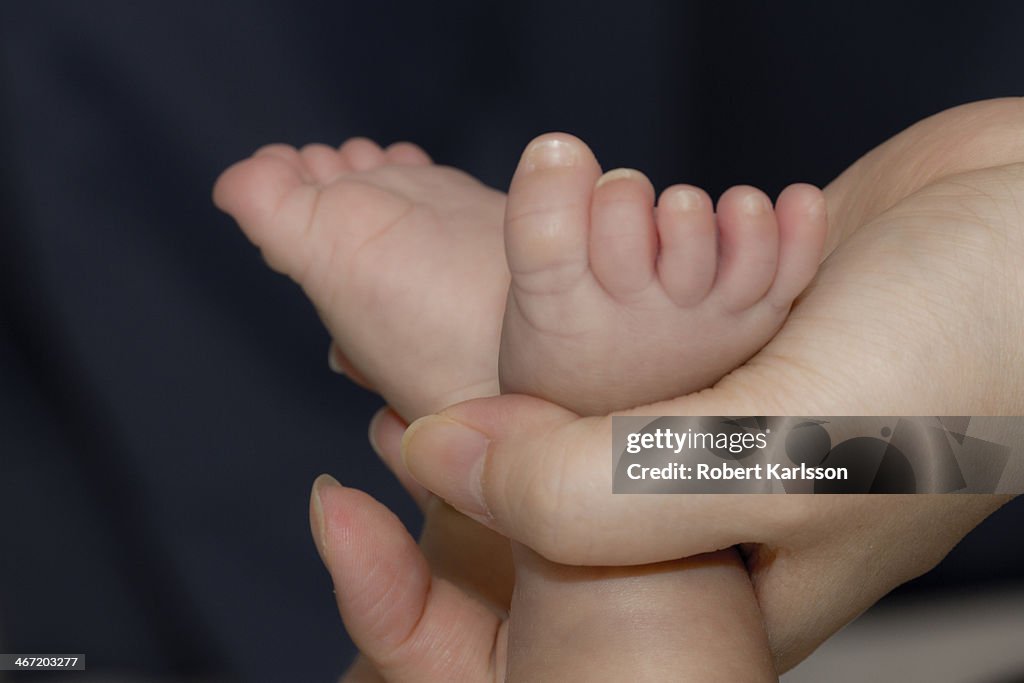 Hand holding baby feet