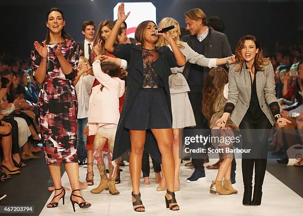 Target Designers Dannii Minogue and Giaan Rooney dance with Australian singer Jessica Mauboy on the runway at the Target show during Melbourne...