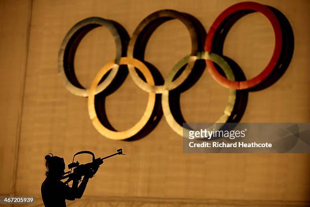 Biathlete shoots during a training session ahead of the Sochi 2014 Winter Olympics at the Laura Cross-Country Ski and Biathlon Center on February 6,...