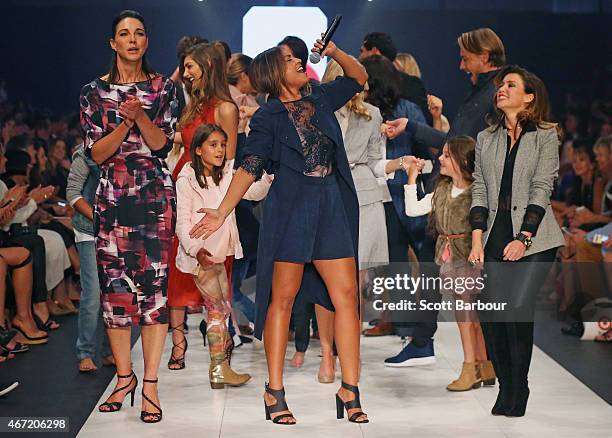 Target designers Dannii Minogue and Giaan Rooney dance with Australian singer Jessica Mauboy on the runway at the Target show during Melbourne...