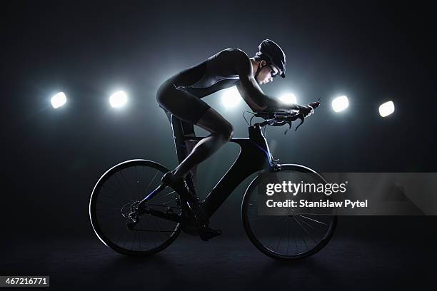 cyclist riding at night in the city - endurance cycling stock pictures, royalty-free photos & images