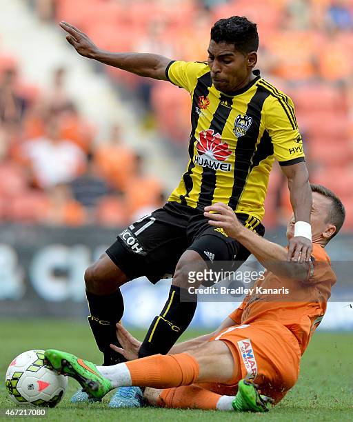 Roy Krishna of Wellington Phoenix is tackled by Matt McKay of the Roar during the round 22 A-League match between the Brisbane Roar and the...