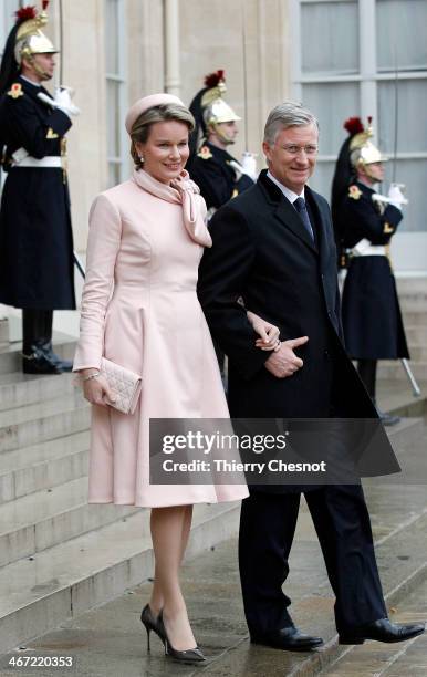 Queen Mathilde of Belgium, flanked by King Philippe of Belgium leave after a lunch with French President Francois Hollande at the Elysee Palace on...