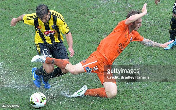 Luke Brattan of the Roar is tackled by Vince Lia of Wellington Phoenix during the round 22 A-League match between the Brisbane Roar and the...