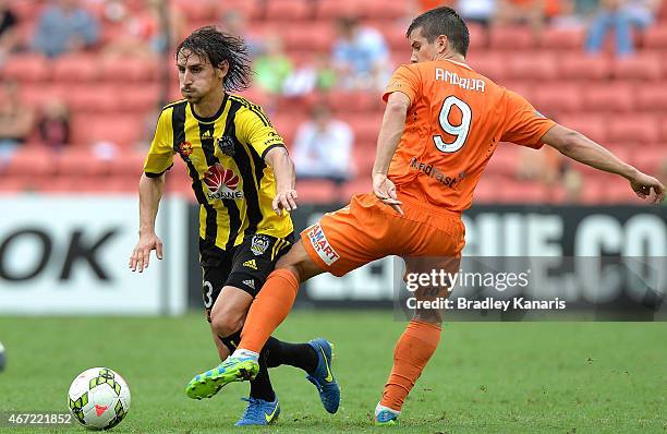 Albert Riera Vidal of Wellington Phoenix gets past the defence of Andrija Kaluderovic of the Roar during the round 22 A-League match between the...