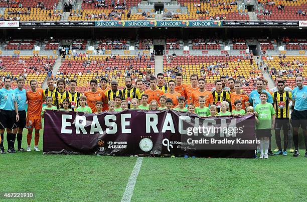 Players from both teams pose for a photo behind a 'Erase Racism' banner before the round 22 A-League match between the Brisbane Roar and the...