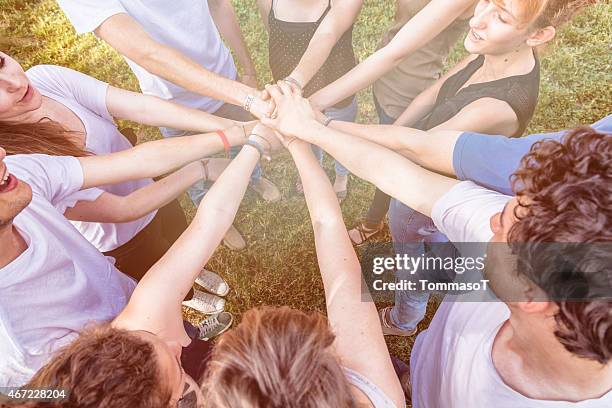 teenagers stacking hands together in circle - hand stack stock pictures, royalty-free photos & images