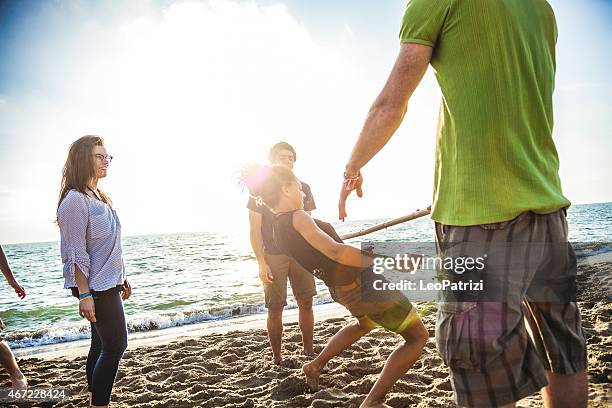 limbo game on the beach - limbo stockfoto's en -beelden