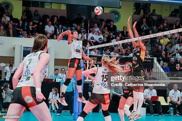 Myriam Kloster of ES Le Cannet-Rocheville VB spikes the ball as Juliann Faucette and Nneka Onyejekwe of RC Cannes block during the Women's Final of...