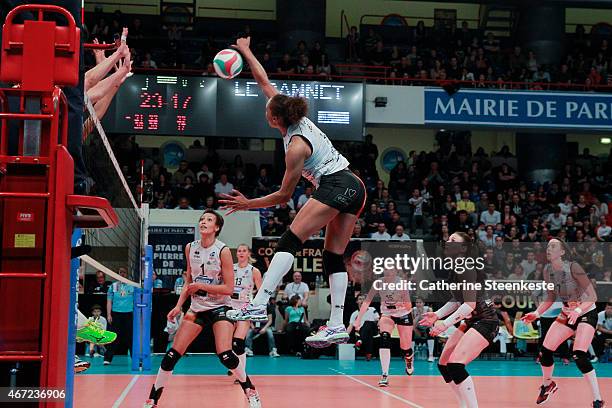 Elisabeth Fedele of ES Le Cannet-Rocheville VB spikes the ball as the RC Cannes block during the Women's Final of La Coupe de France between RC...