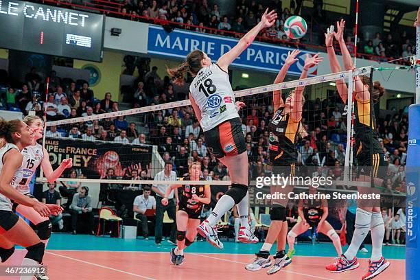 Marina Zambelli of ES Le Cannet-Rocheville VB spikes the ball as Victoria Ravva and Logan Tom of RC Cannes block during the Women's Finale of La...