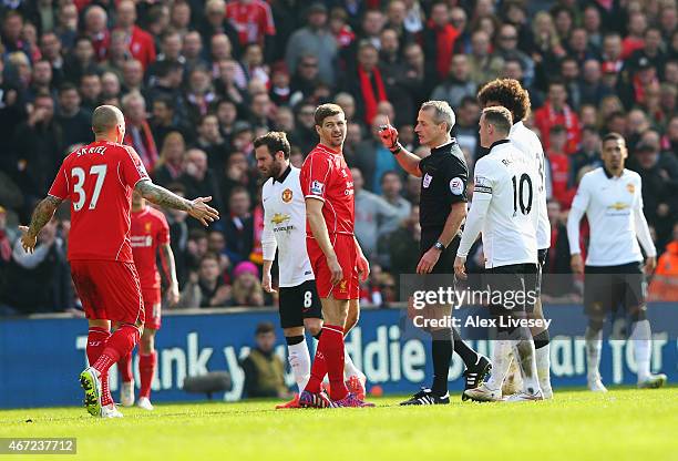 Steven Gerrard of Liverpool is shown the red card by referee Martin Atkinson during the Barclays Premier League match between Liverpool and...