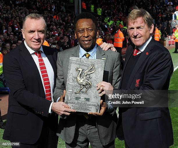 Pele is awarded a plaque by Ian Ayre Chief Executive of Liverpool and Kenny Dalglish during the Barclays Premier League match between Liverpool and...