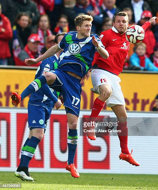 Andre Schuerrle of Wolfsburg jumps for a header with Daniel Brosinski of Mainz during the Bundesliga match between 1. FSV Mainz 05 and VfL Wolfsburg...