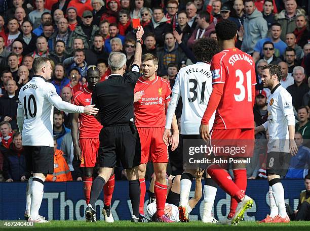 Steven Gerrard of Liverpool is shown the red card by referee Martin Atkinson during the Barclays Premier League match between Liverpool and...