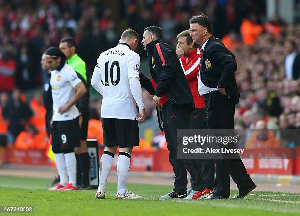 Louis van Gaal, manager of Manchester United and assistant Ryan Giggs talk to Wayne Rooney during the Barclays Premier League match between Liverpool...
