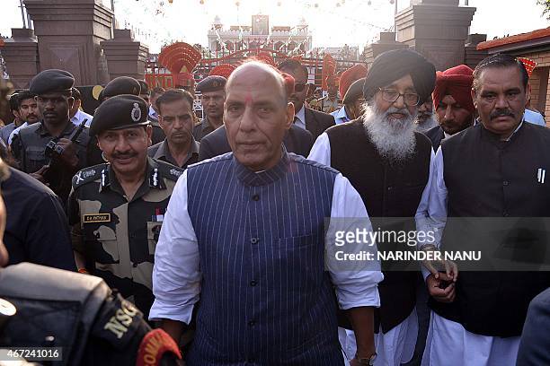Union Home Minister Rajnath Singh , Punjab state chief minister Parkash Singh Badal and Border Security Force Director General DK Pathak walk during...