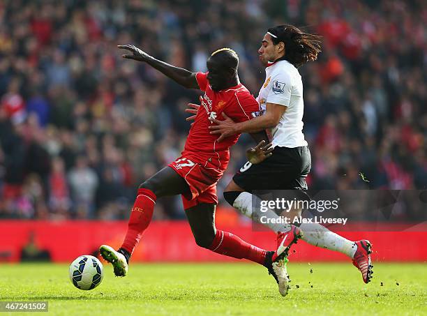 Mamadou Sakho of Liverpool is challenged by Radamel Falcao of Manchester United during the Barclays Premier League match between Liverpool and...