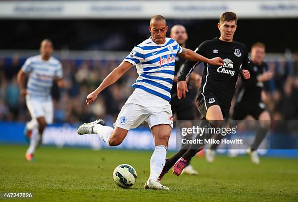 Bobby Zamora of QPR shoots as he is closed down by John Stones of Everton during the Barclays Premier League match between Queens Park Rangers and...