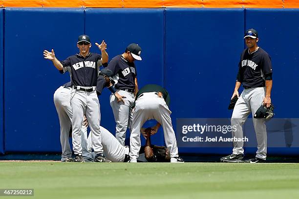 Manager Joe Girardi signals for a cart after checking on Jose Pirela of the New York Yankees after he was injured fielding a ball against the New...