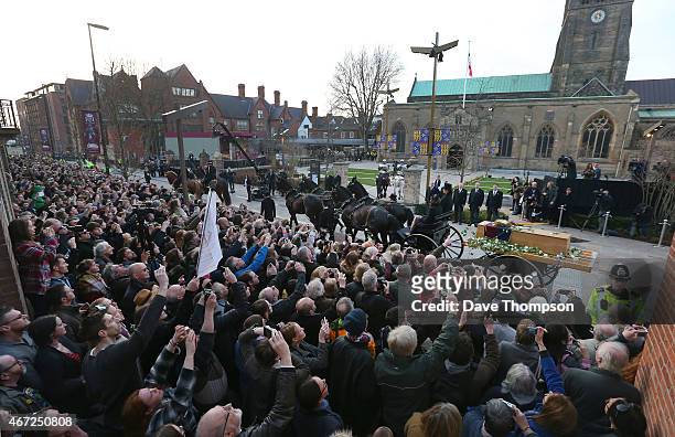 Crowds watch the coffin containing the remains of King Richard III arrive for its reinterment at Leicester Cathedral following a procession through...