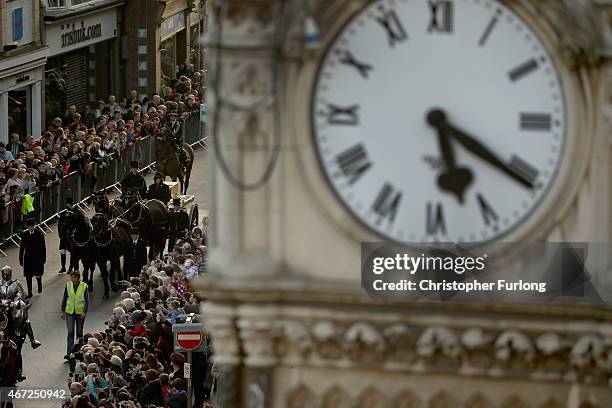 In the distance from a clock tower, the coffin containing the remains of King Richard III is carried in procession past the memorial clock for...