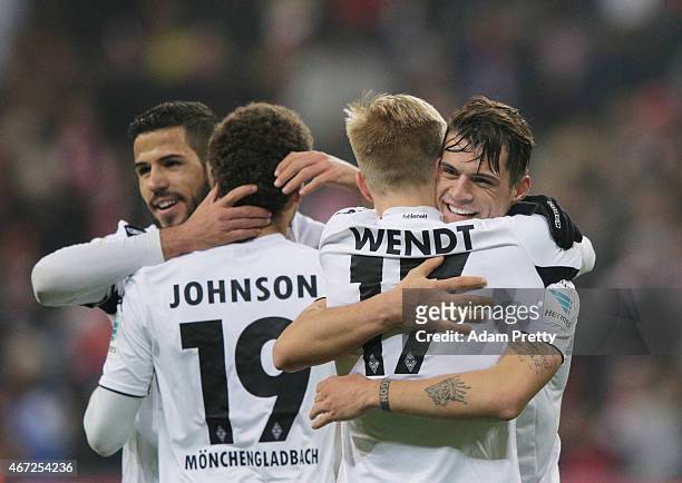 Granit Xhaka of Borussia Moenchengladbach celebrates victory with Oscar Wendt after the Bundesliga match between Bayern Muenchen and Borussia...